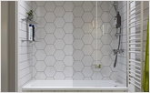 The geometry in tile in bathroom with glass curtain
