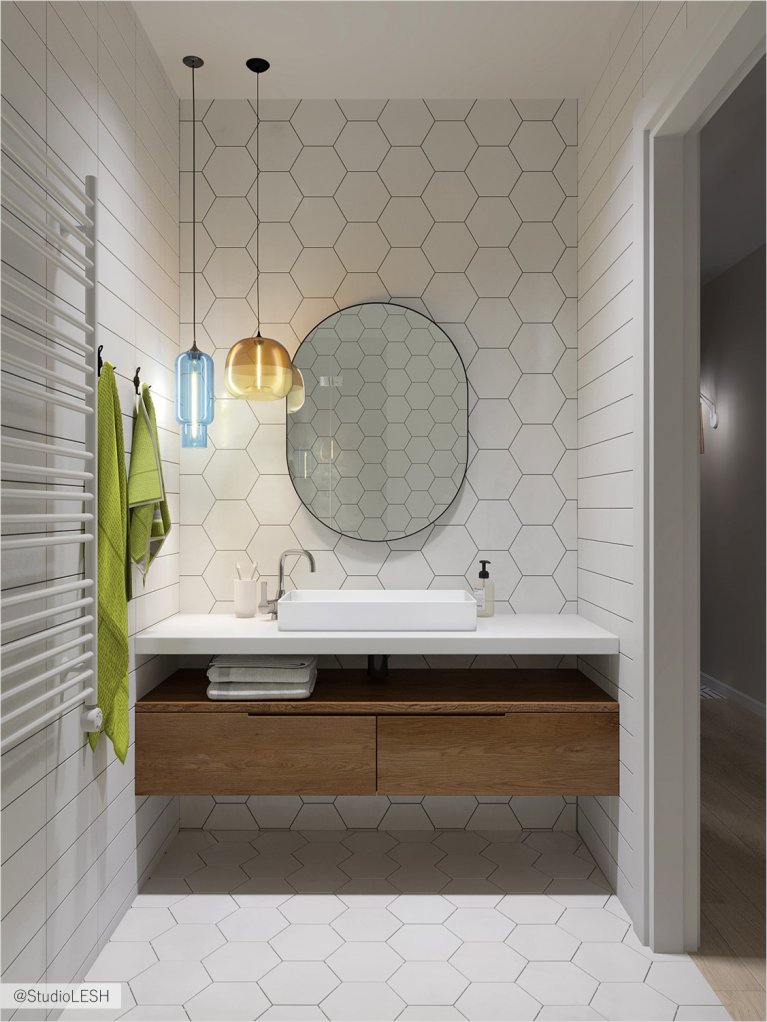 Oval mirror in the bathroom with lamps from Jeremy Pyles and Niche Modern collection