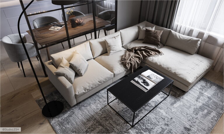 Большой мягкий диван в гостиной с дизайнерским столиком