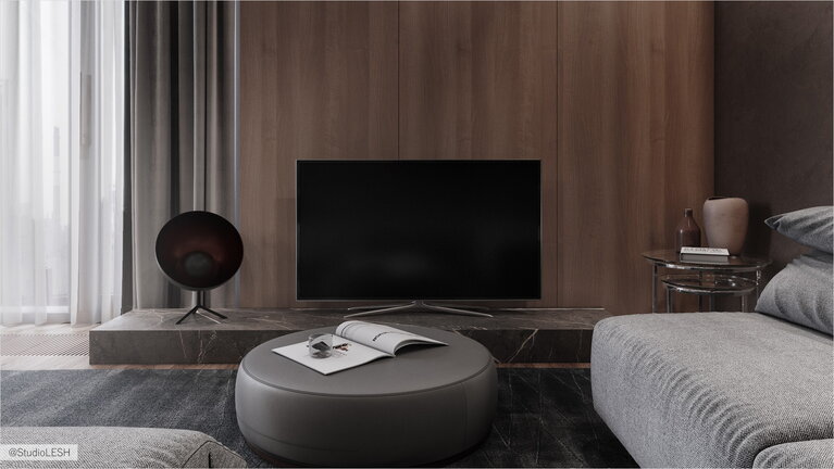 TV in the living room with a coffee ottoman