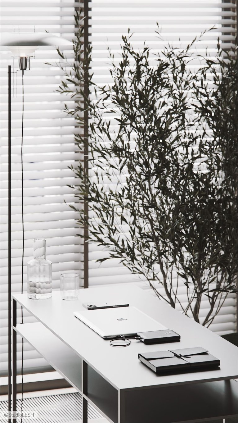 Современное рабочее место с белым столом, ноутбуком, смартфоном и канцелярскими принадлежностями у окна с жалюзи.