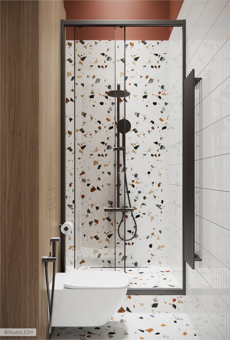 Интерьер современной ванной комнаты с душевой кабиной из стекла, унитазом, раковиной и отделкой плиткой под кирпич и терраццо.