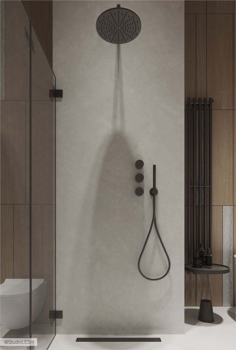 В современной ванной комнате с отделкой под дерево установлена душевая кабина с прозрачными стеклянными дверями и черным тропическим душем.