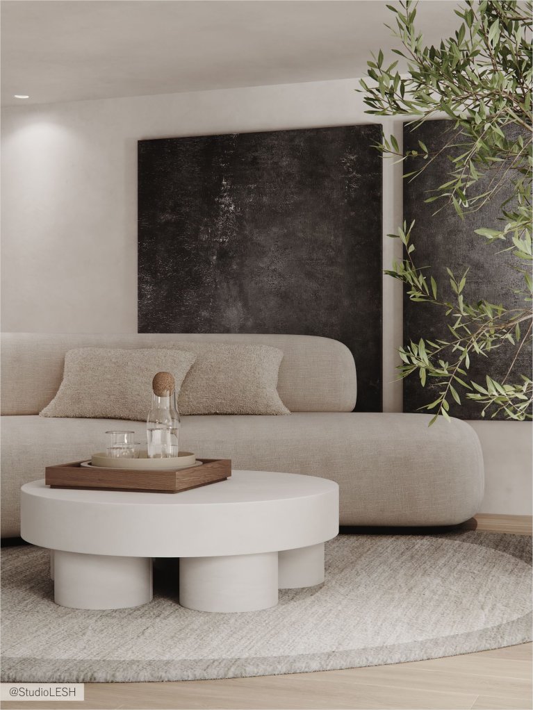 Интерьер современной гостиной с белым диваном, серым креслом, круглым столиком, торшером и большим книжным шкафом на заднем плане.