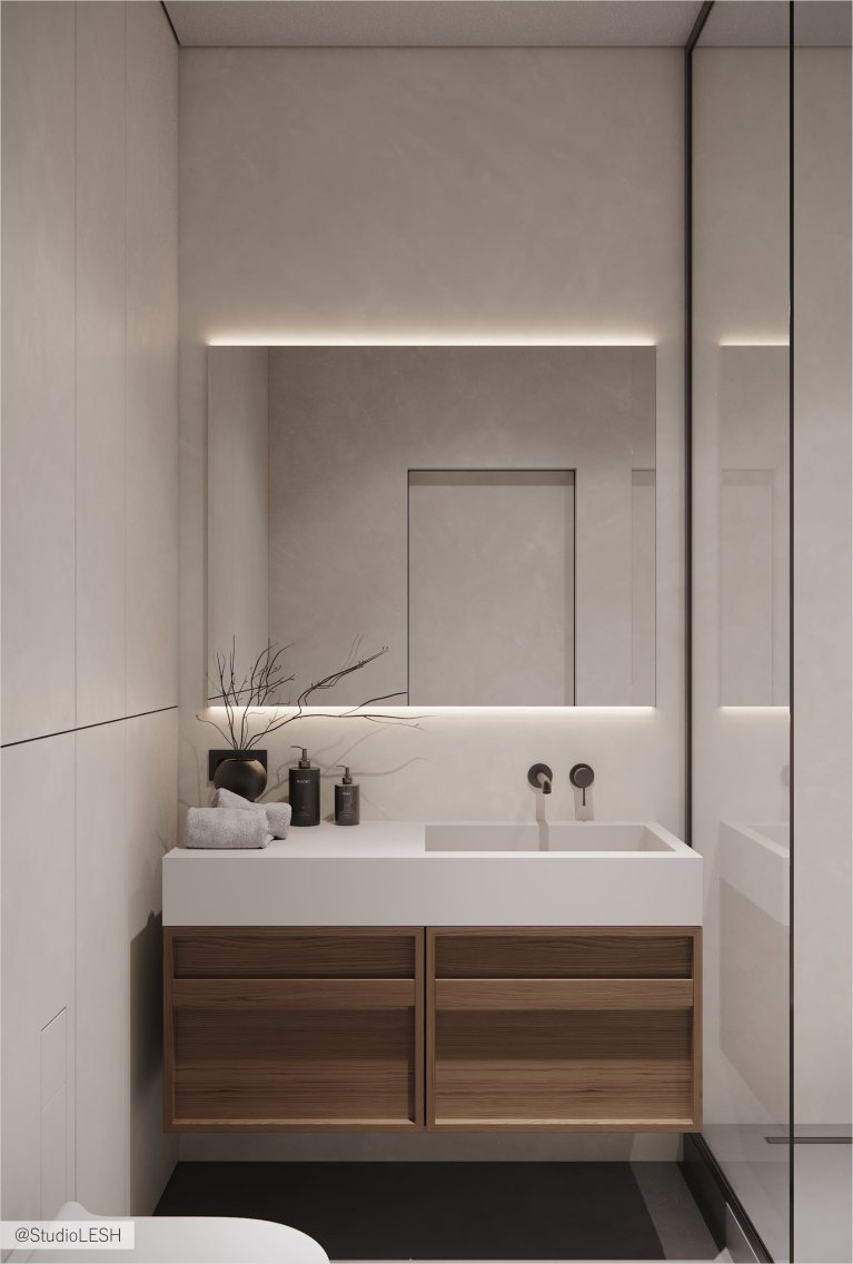 Современная ванная комната с подвесной тумбой и зеркалом с подсветкой.