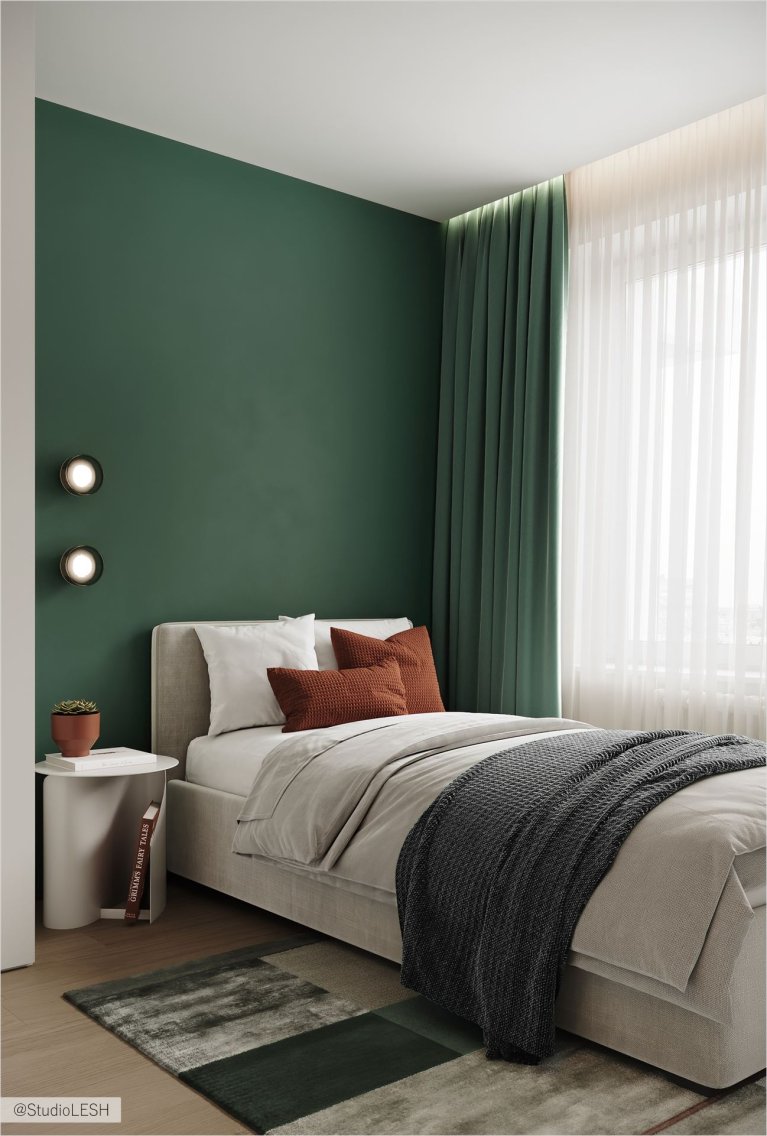 Спальня, где царит атмосфера спокойствия и уюта. В центре комнаты стоит большая кровать с мягким изголовьем. Рядом с кроватью находится рабочий стол с ноутбуком, а также прикроватная тумбочка с книгами. На стене висит картина, которая добавляет интерьеру индивидуальности