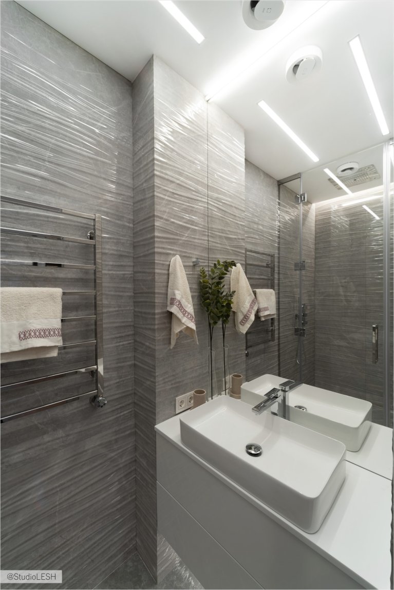 Функциональная и стильная ванная комната с серыми стенами, где сочетаются удобство и эстетика